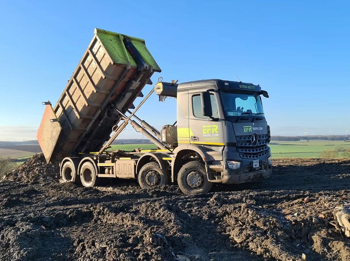 An EFR Skips RoRo lorry tipping a roll-on roll-off container